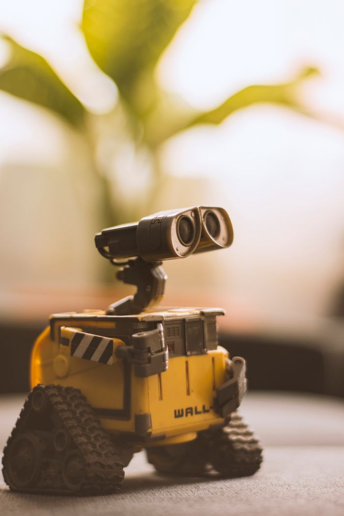 Charming toy robot placed on a desk, perfect for tech and nostalgia themes.