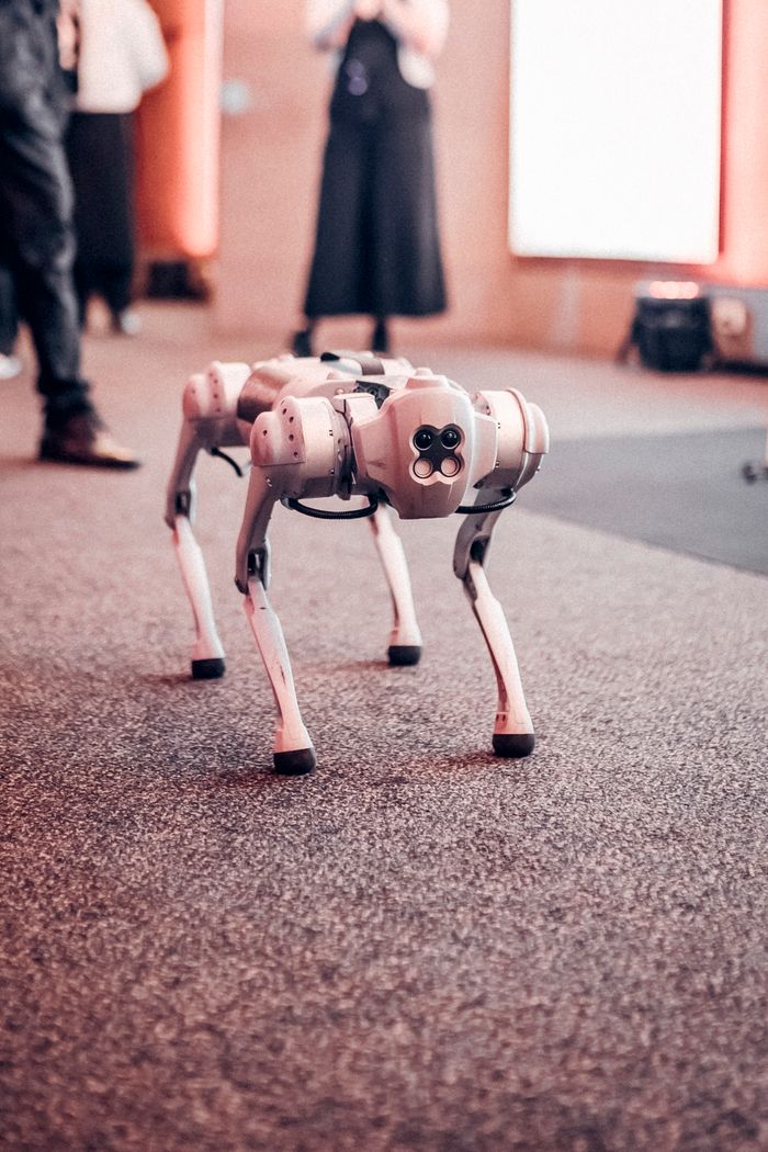 Robotic dog displayed at a tech event showcasing innovative technology.